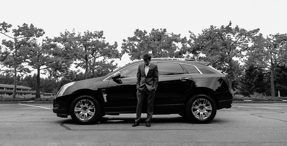 Groom standing in front of car Black and white. Perfect Wedding Photos' Highland 
